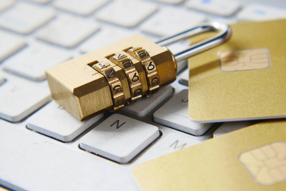 Close-up of hands reviewing credit card statements with insurance documents nearby